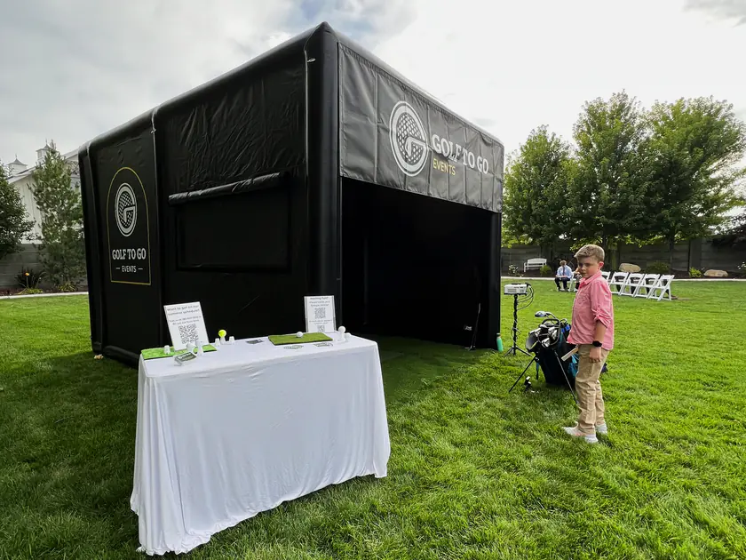 Golf to Go Events mobile golf simulator tent set up on a lawn at a Utah wedding venue